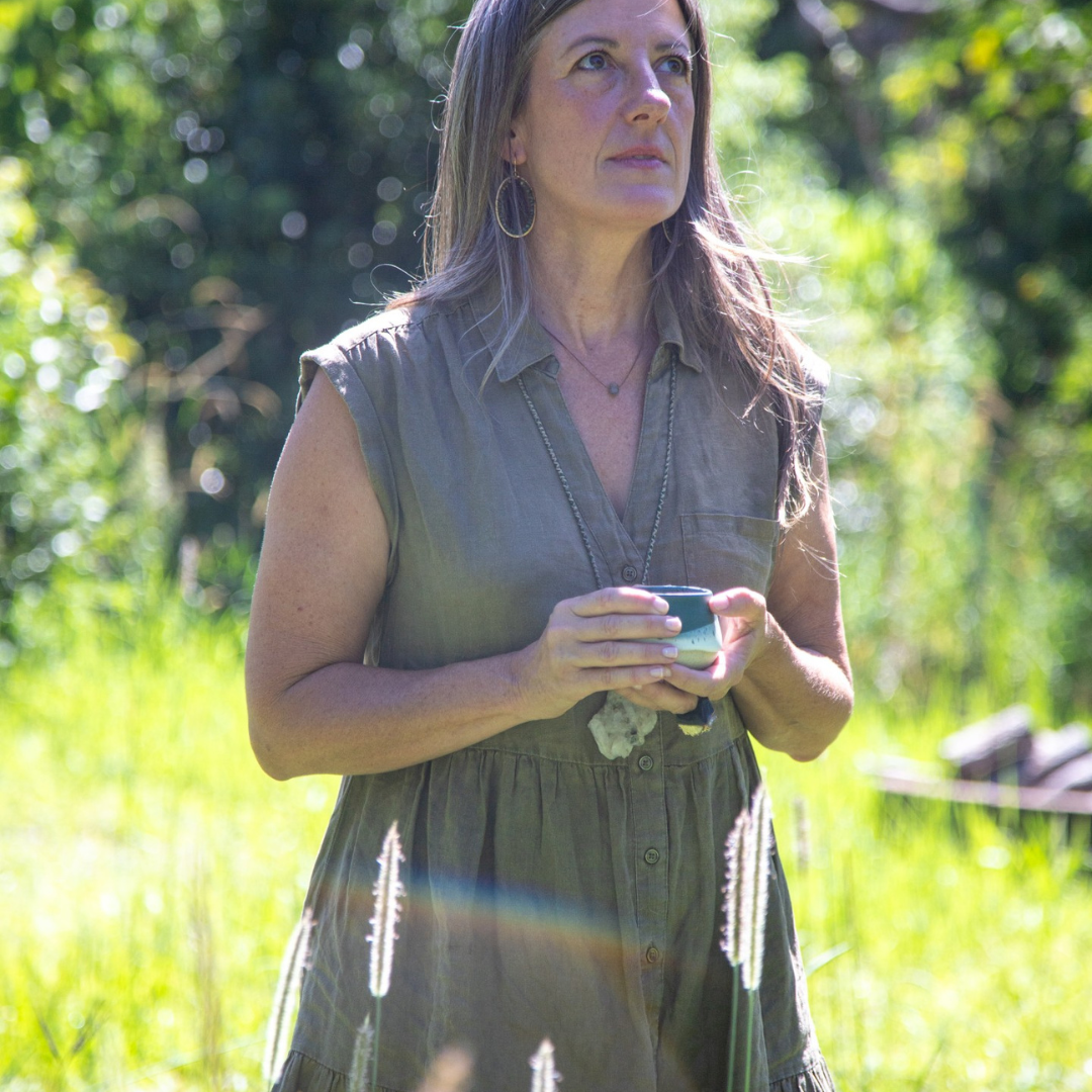 Woman drinking cacao in nature as calming ritual