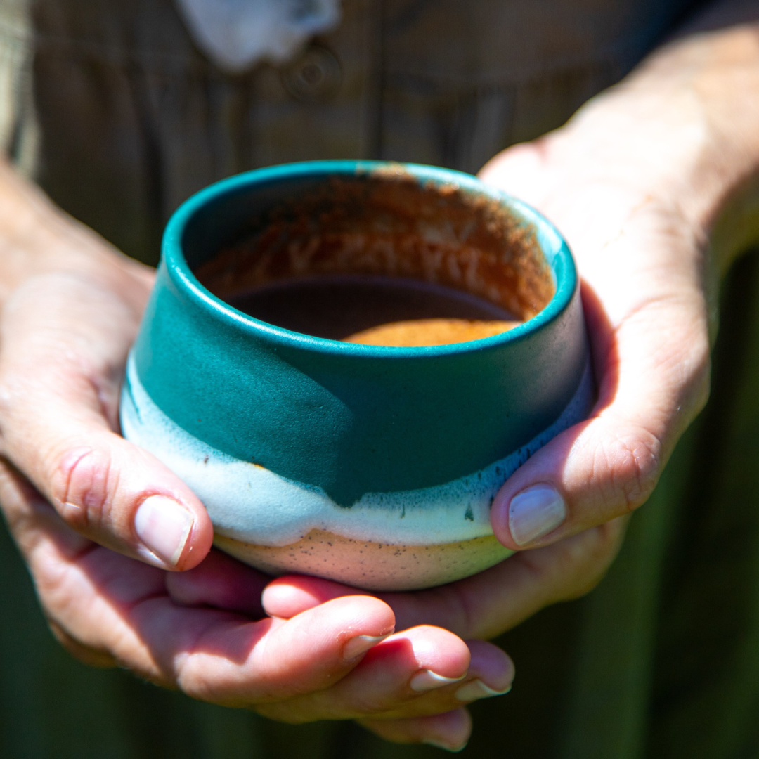 Woman holding ceremonial cacao cup as part of calming ritual